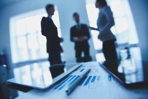 financial-report-with-co-workers-blurred-background-426547