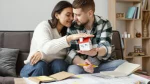 medium-shot-couple-holding-small-house-247839
