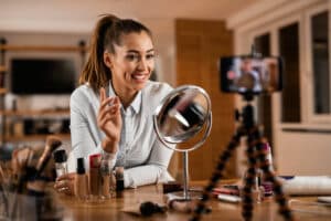 smiling-female-influencer-talking-about-beauty-products-while-vlogging-from-home-379905